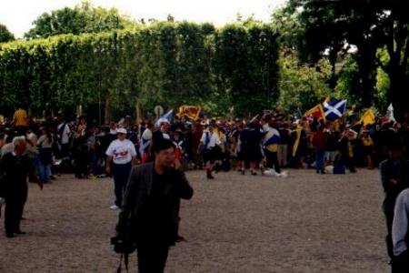 Scots fans gather under the Eiffel Tower on the day of the Brazil game